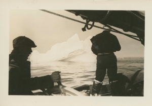 Image of Heading to Baffin Island. Donald MacMillan taking picture of iceberg